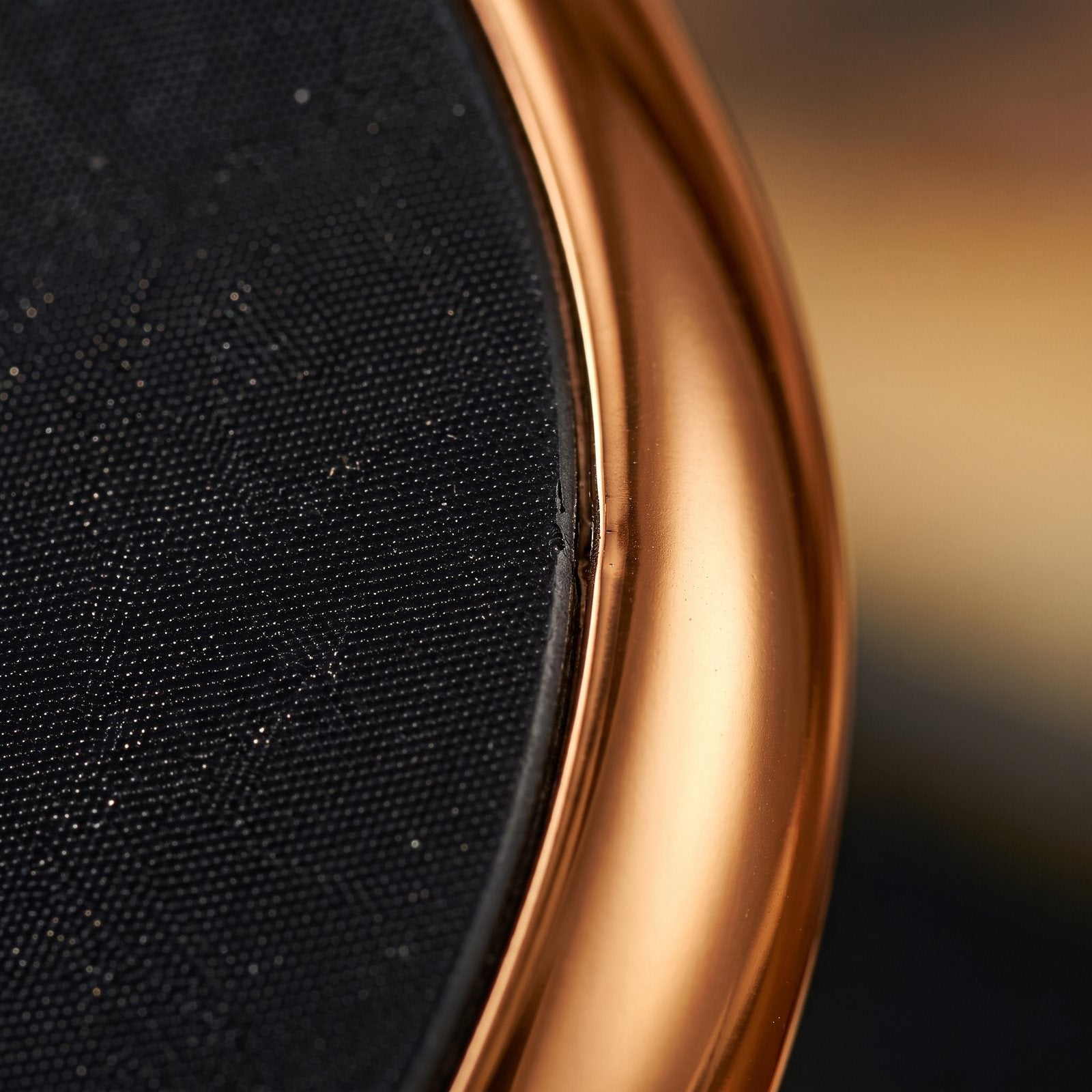 Close-up of the textured glass surface and gold edge